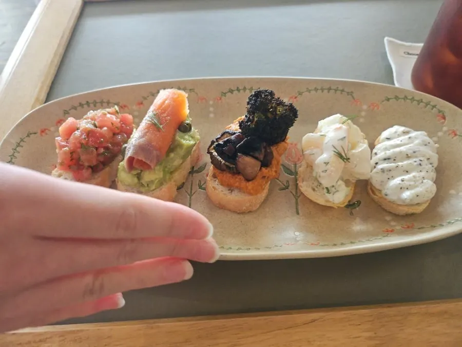 Bite-size sandwiches plated on a long dish