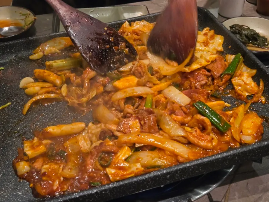 300g of duck stir-fry cooking on the grill