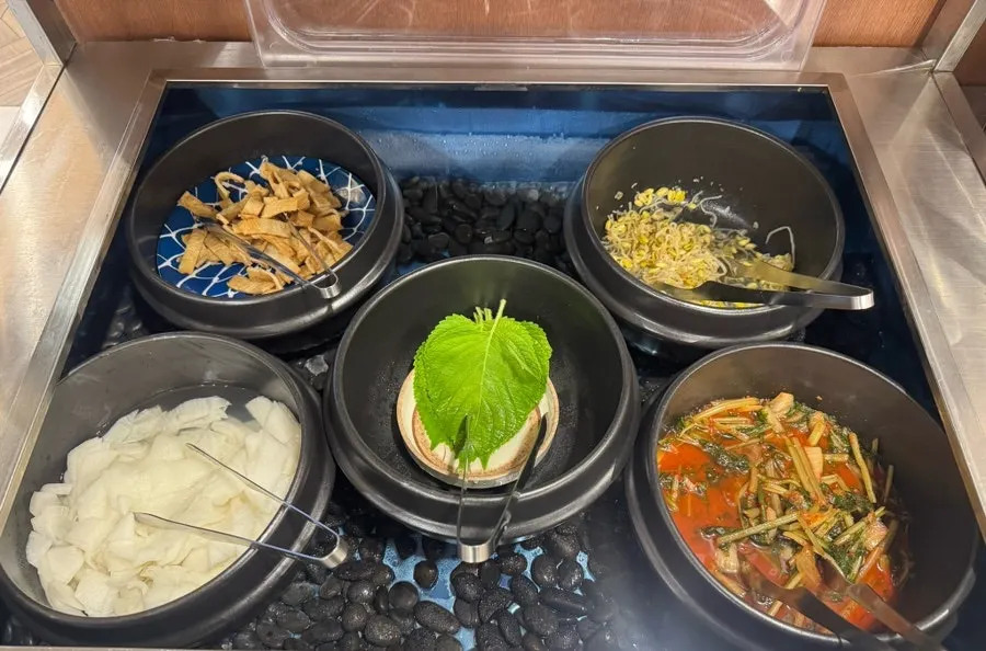 Warm udon broth scooped from the self-bar