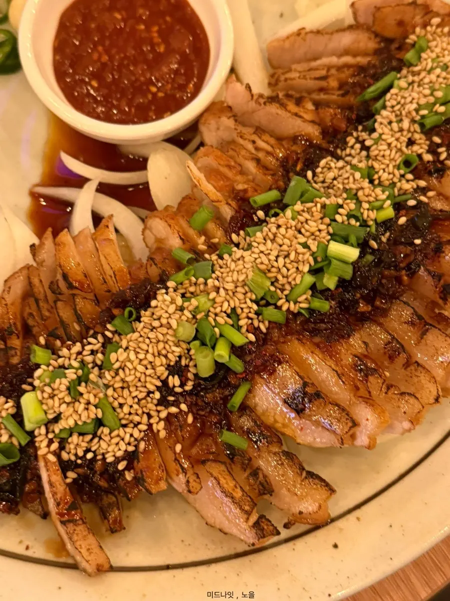 Pork jowl soy-braise served with chives and potato salad