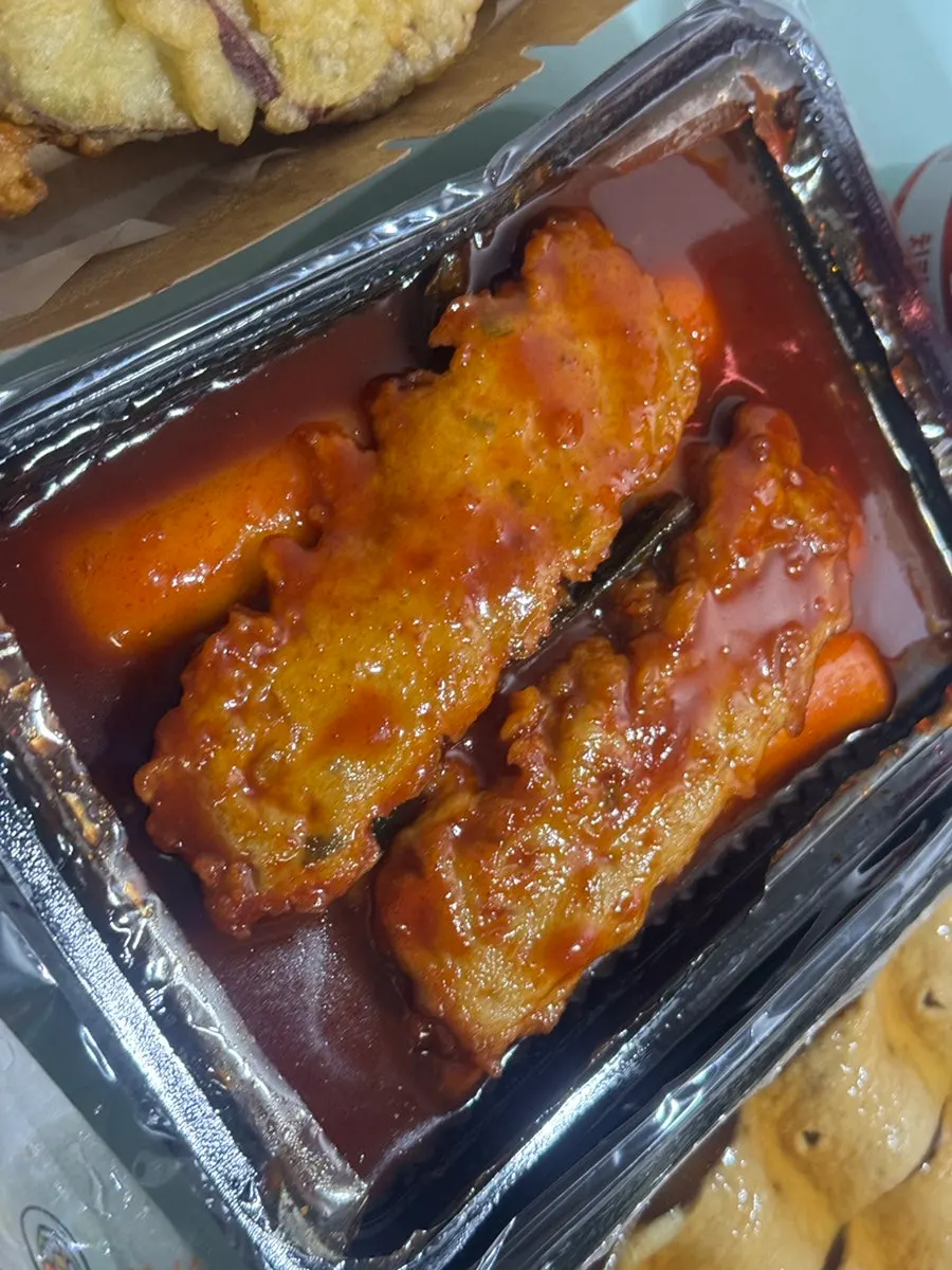 Rice tteokbokki packed in a takeout container