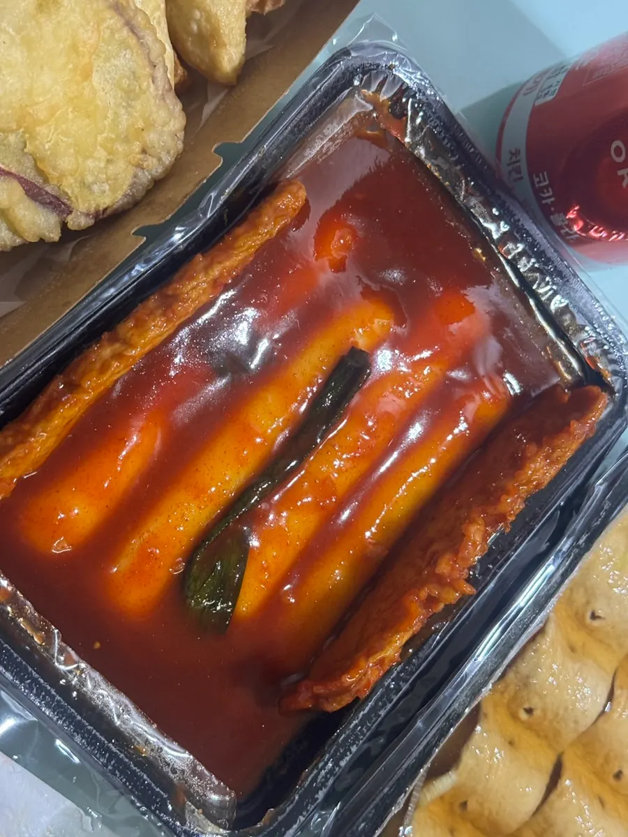 Close-up of rice tteokbokki coated in spicy-sweet sauce