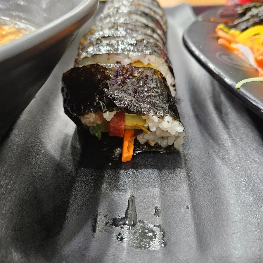 A thickly sliced roll of ttaengcho tuna gimbap