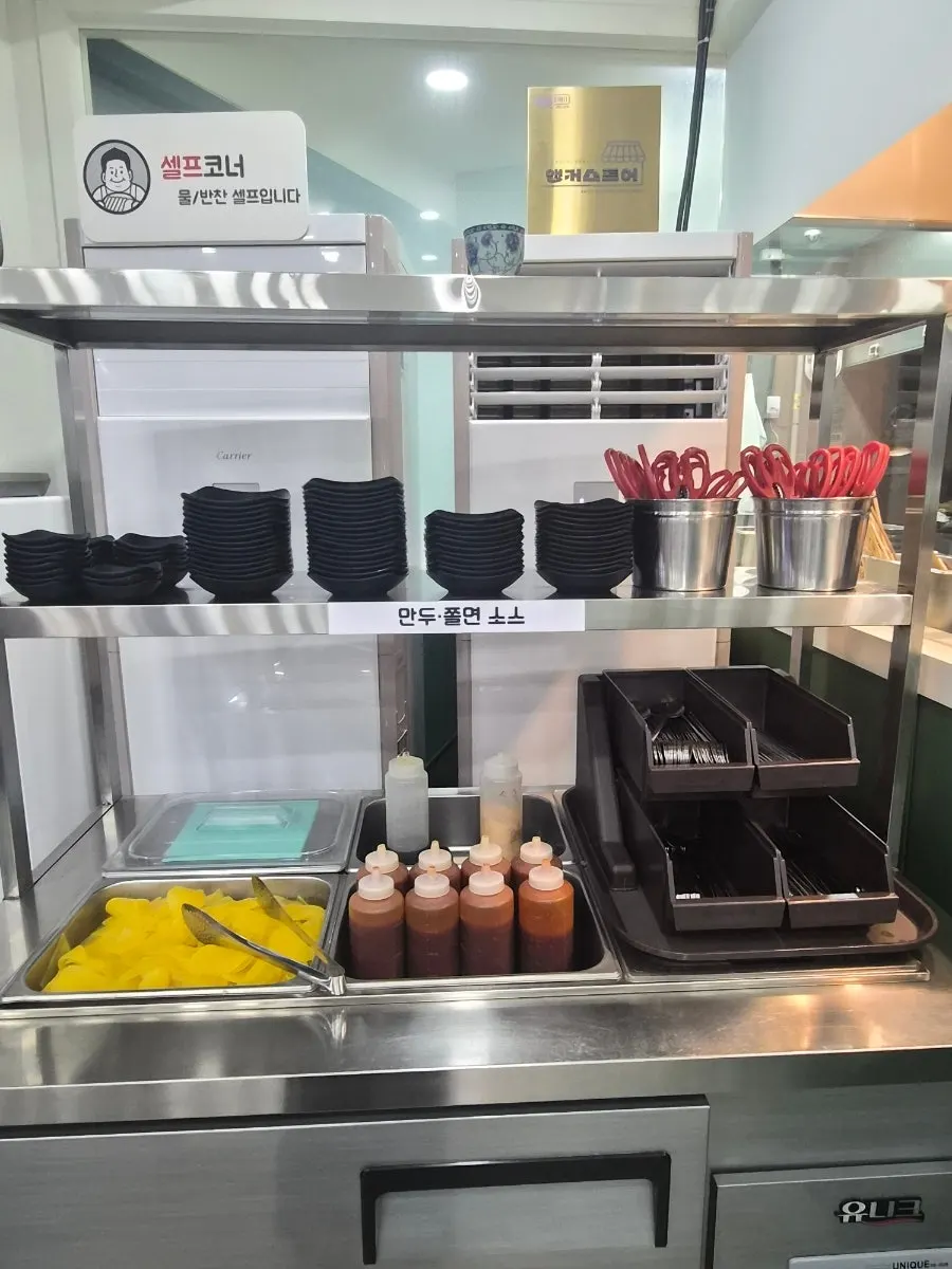 Self-service corner with pickled radish and sauces