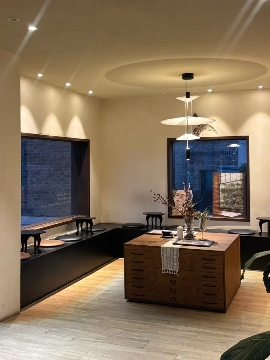 Interior of Deokmi Gijang Branch lit with warm lighting