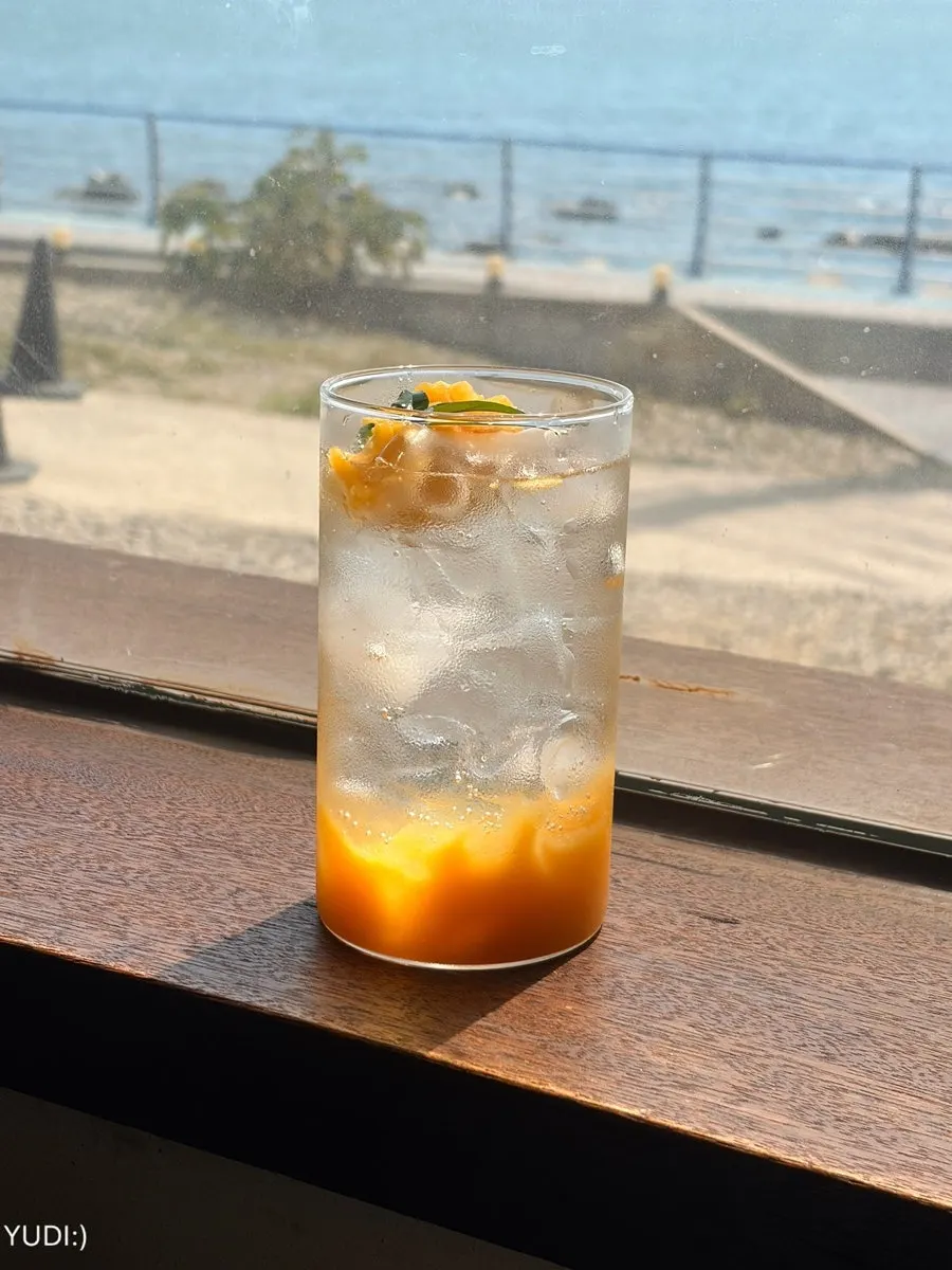 Mugwort latte placed by the ocean-view window