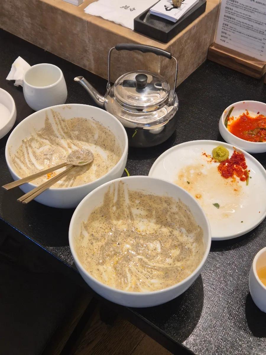 Eating cold soy mixed kalguksu with chopsticks