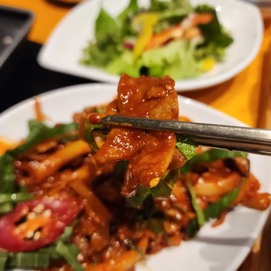 Table spread of grilled mackerel and stir-fried pork