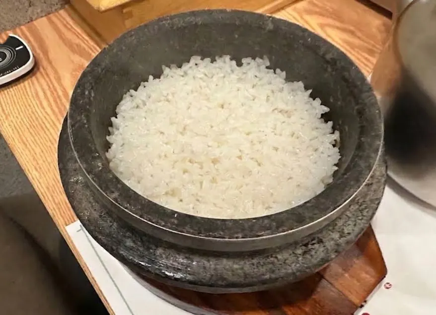 Table setting with stone pot rice and healthy side dishes