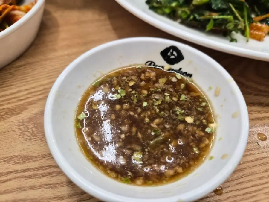 Table with kalguksu and minari shrimp jeon together