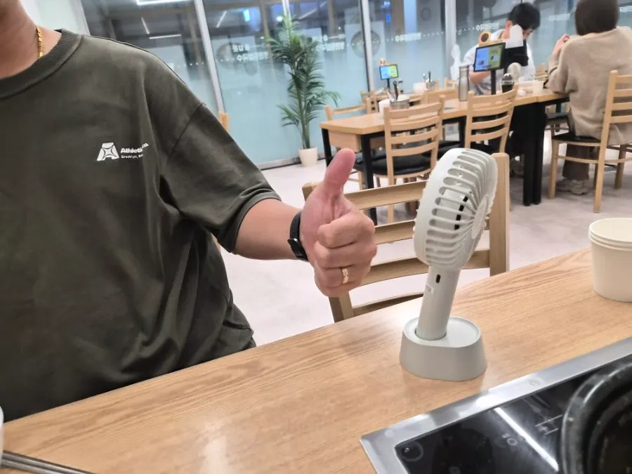 Stand-up handheld fan placed on the table