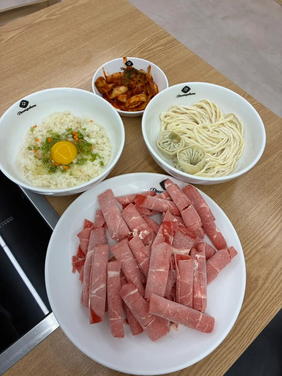Mushroom kalguksu shabu-shabu spread for two