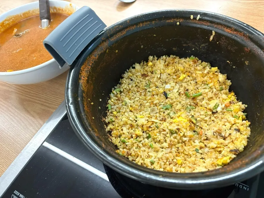 Fried rice being cooked after removing some broth