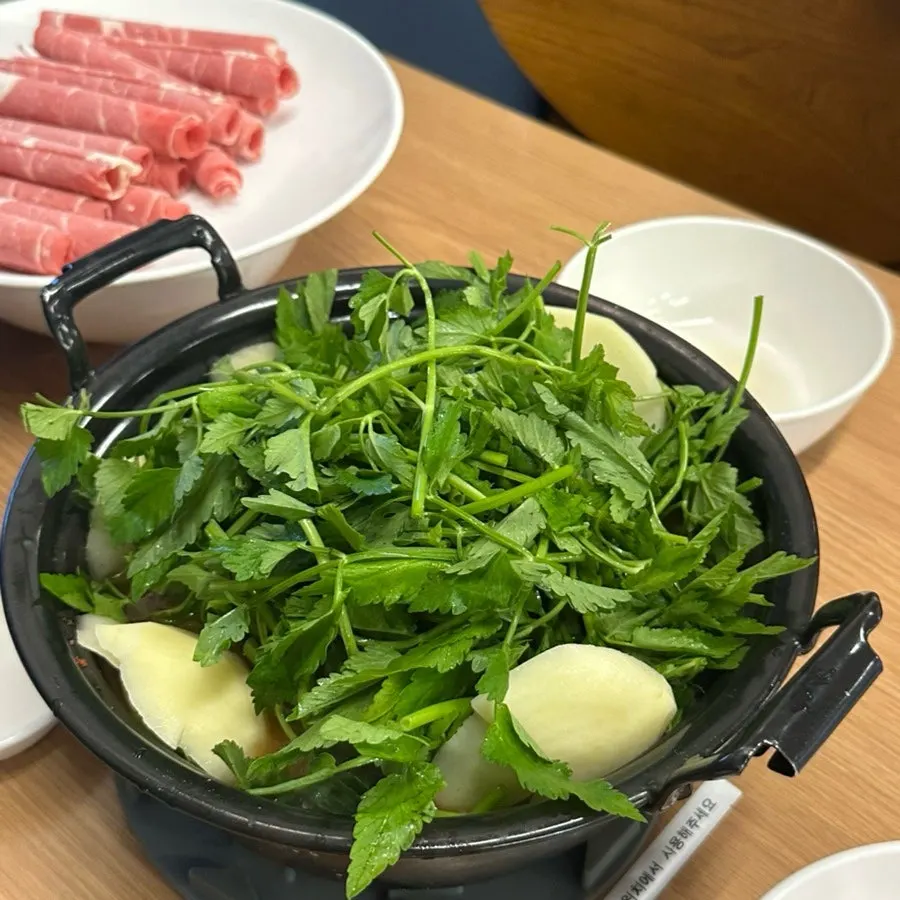 Dipping shabu beef into the broth