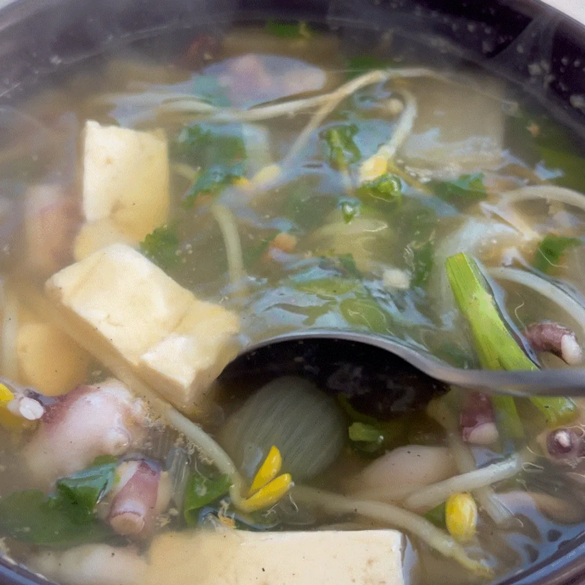 A full table of nakji haejangguk at Deungdae Gotgan in front of Deungdae Beach