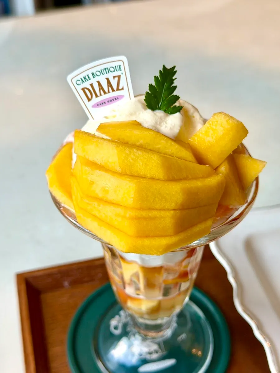 Peach parfait topped with a scoop of ice cream