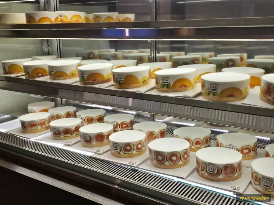 Fruit-topped cream cakes on display