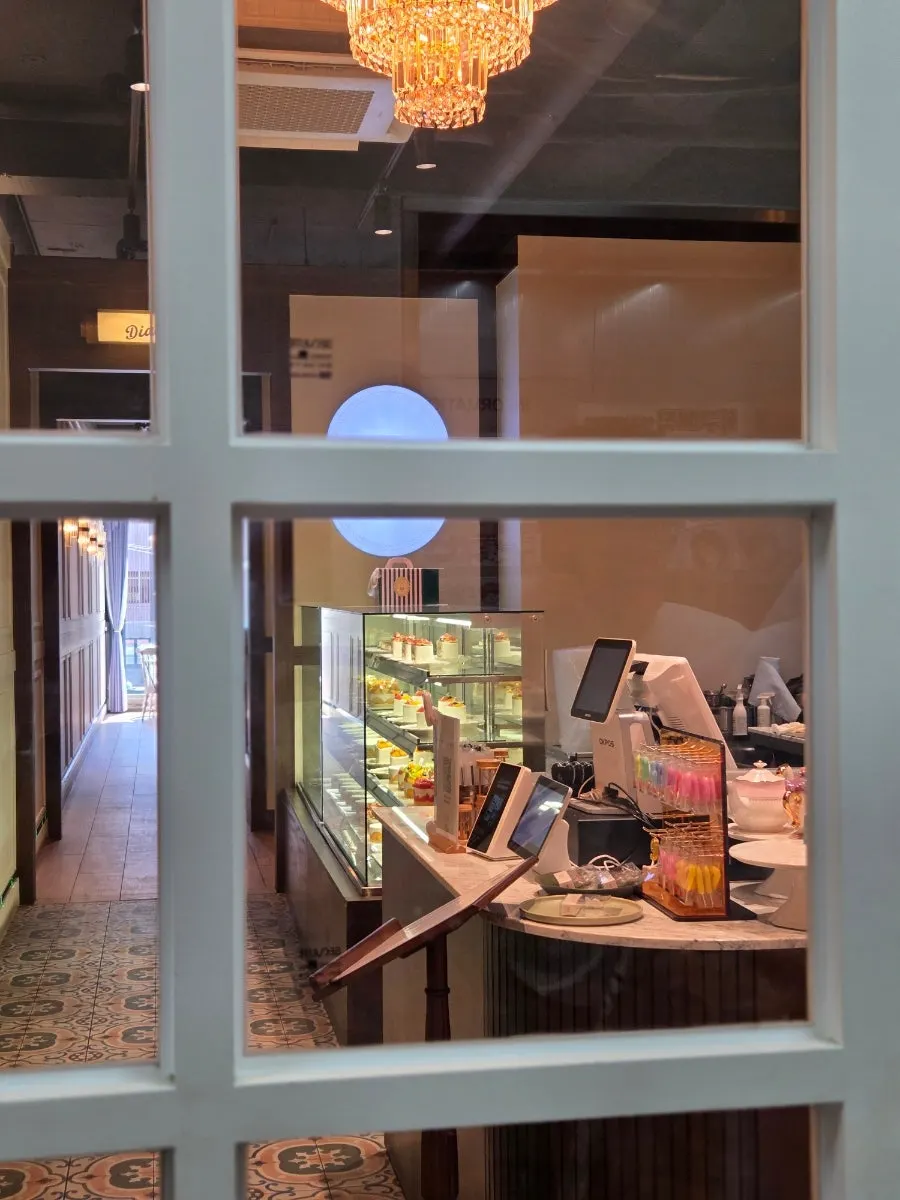 Store sign advertising cake, hand-drip coffee, and tea