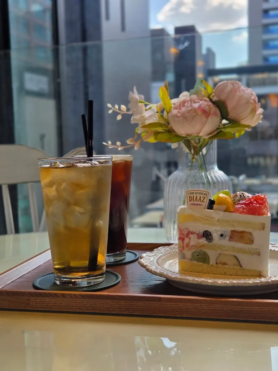 Cake and drinks set up on a window-side table