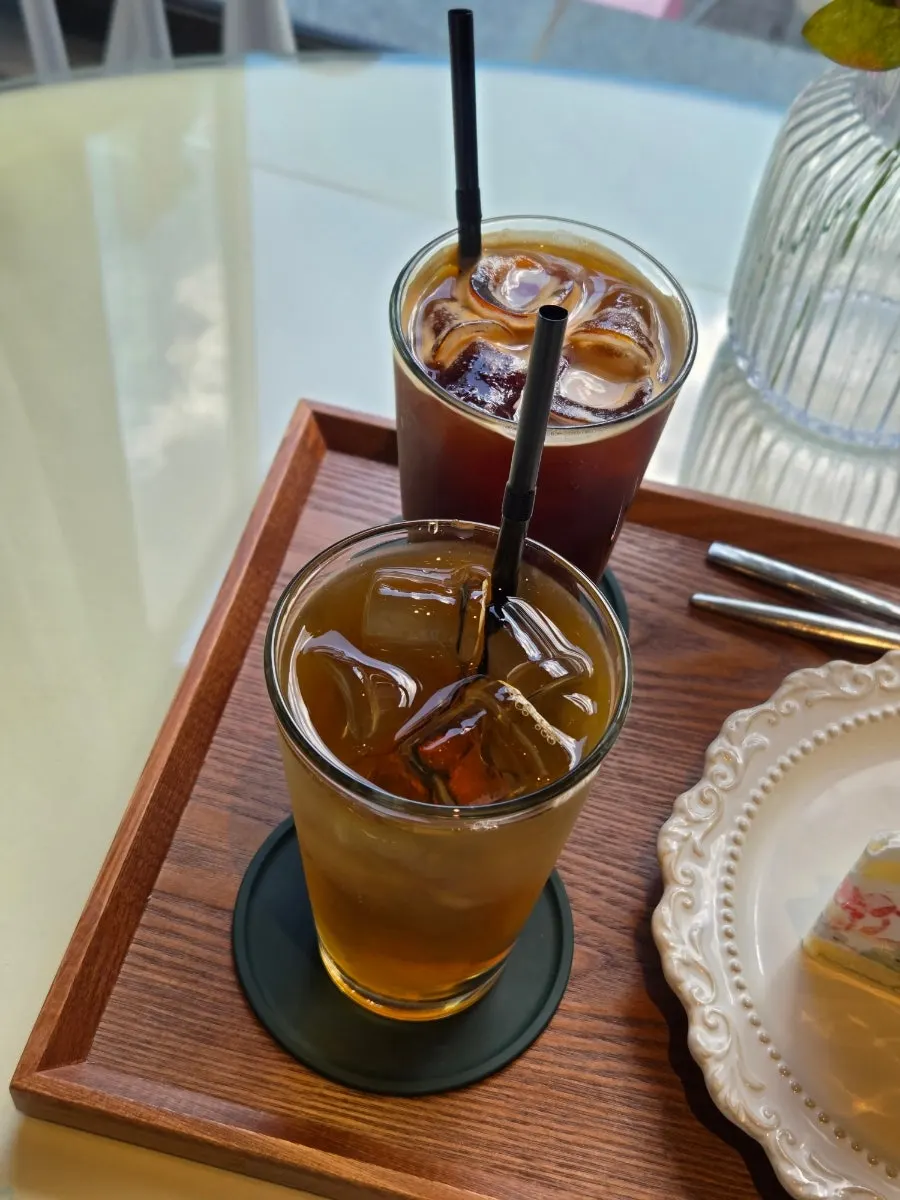 Iced americano at a sunlit window seat