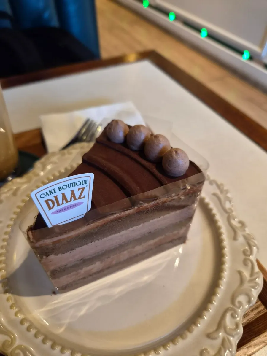 Slice of choco cream cake piled high with chocolate cream