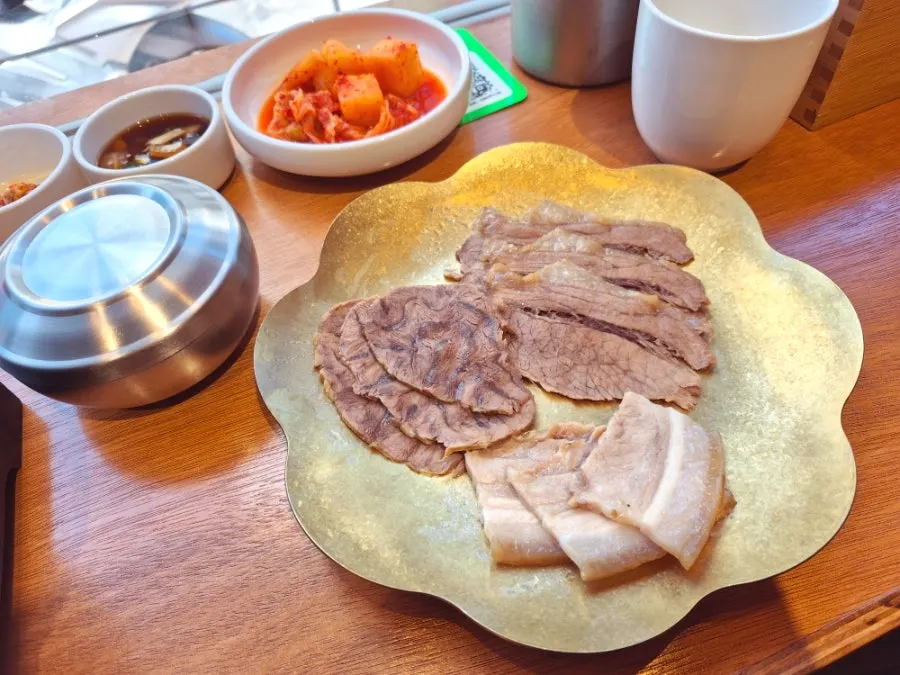 Table with side dishes and a bowl of rice