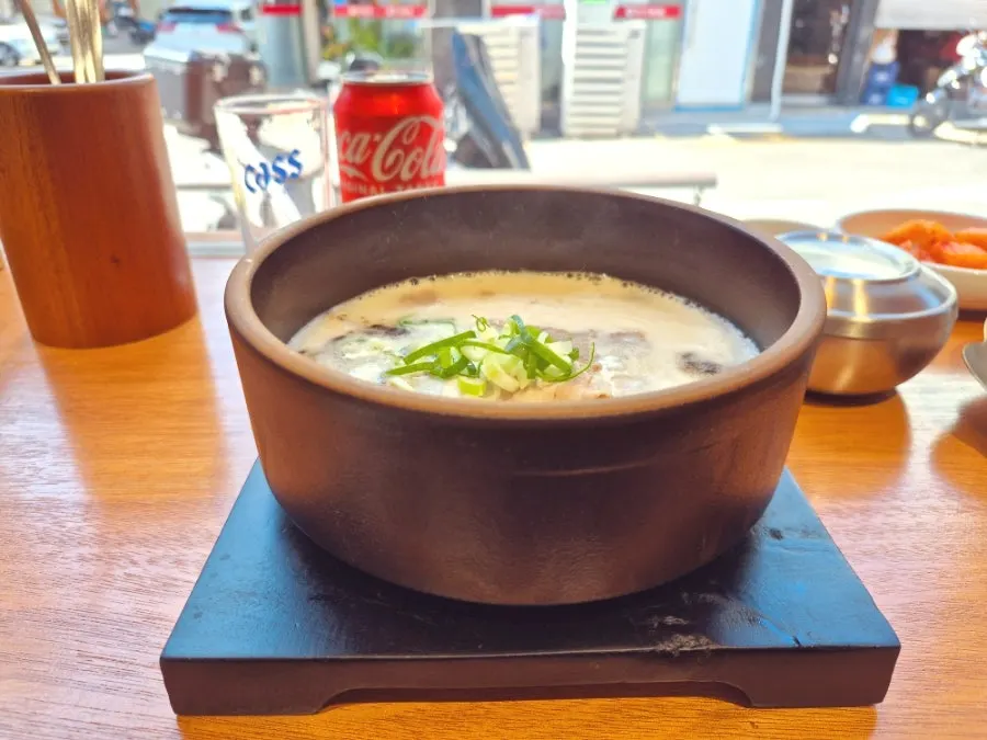 A piece of sample suyuk dipped in sauce