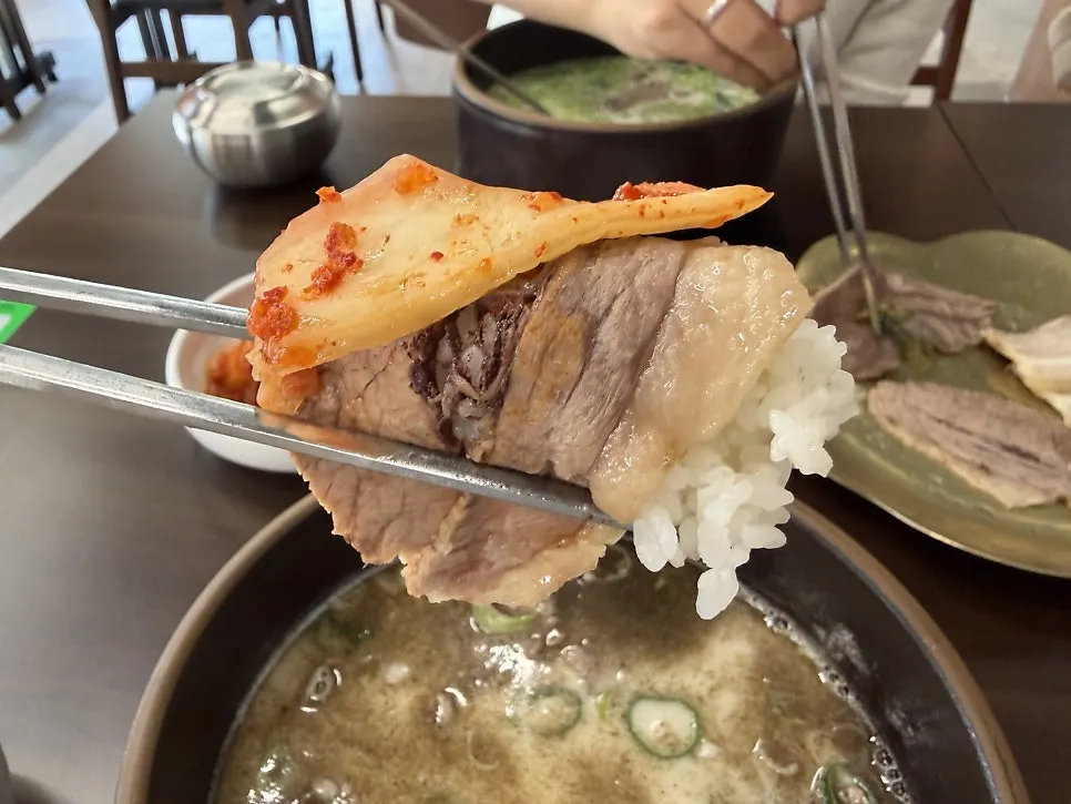 A piece of boiled pork placed on top of rice