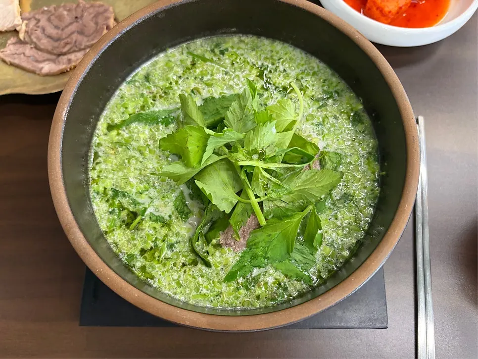 Minari beef gomtang piled high with fresh minari