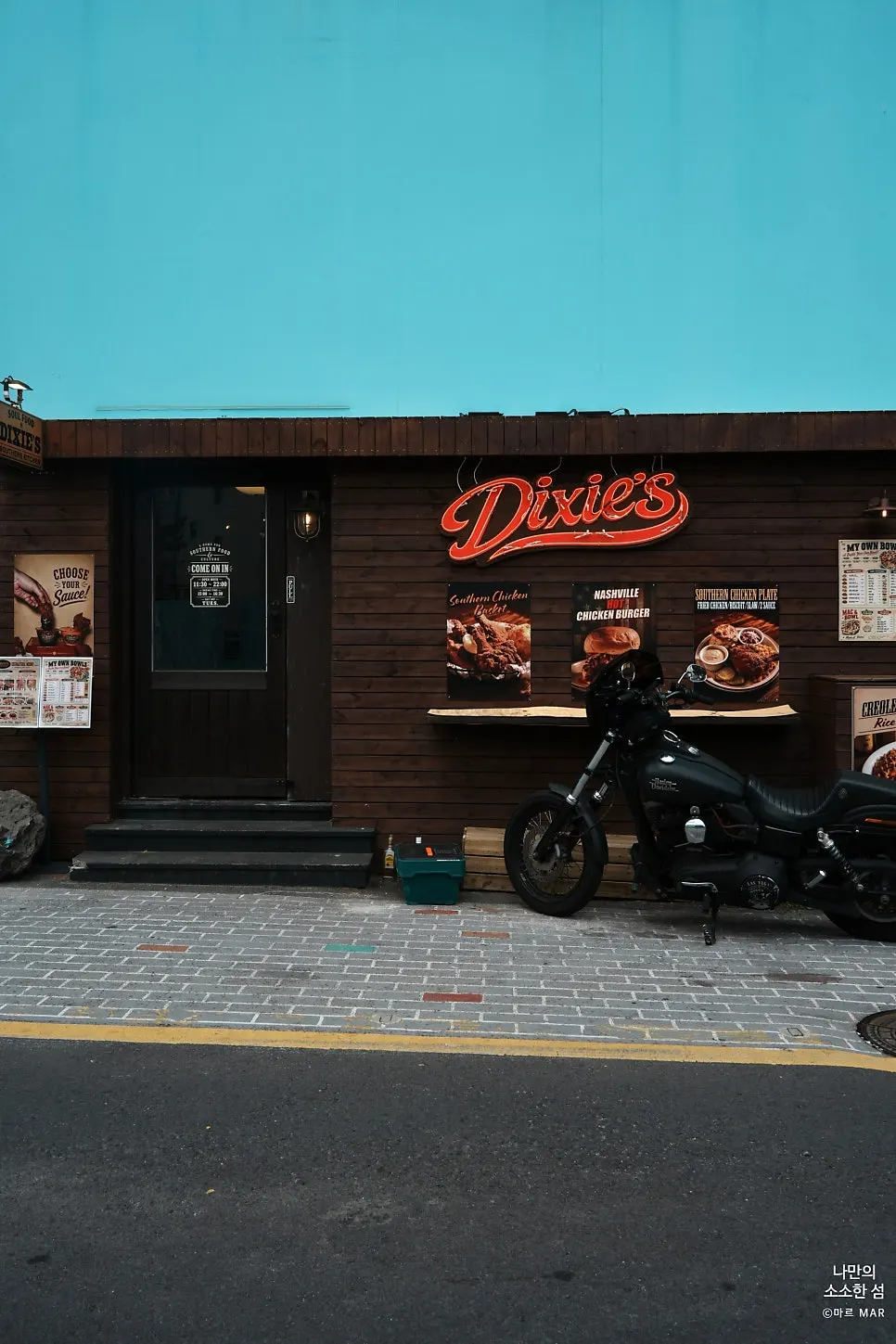 Dixie's exterior with blue walls and wood paneling