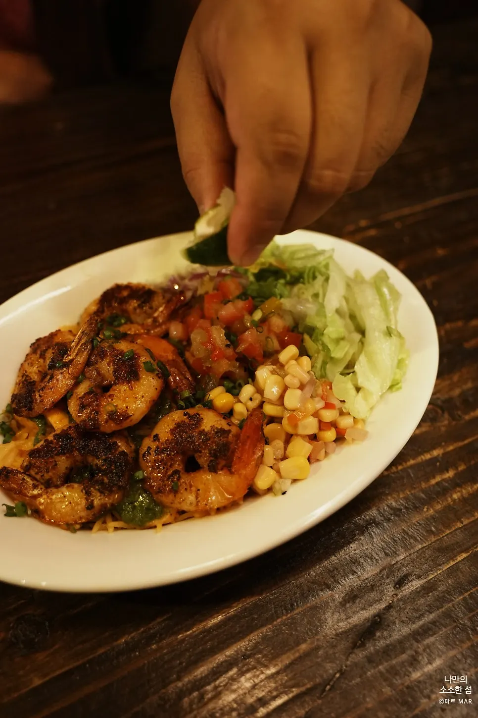 Six Cajun-seasoned shrimp on top of the bowl