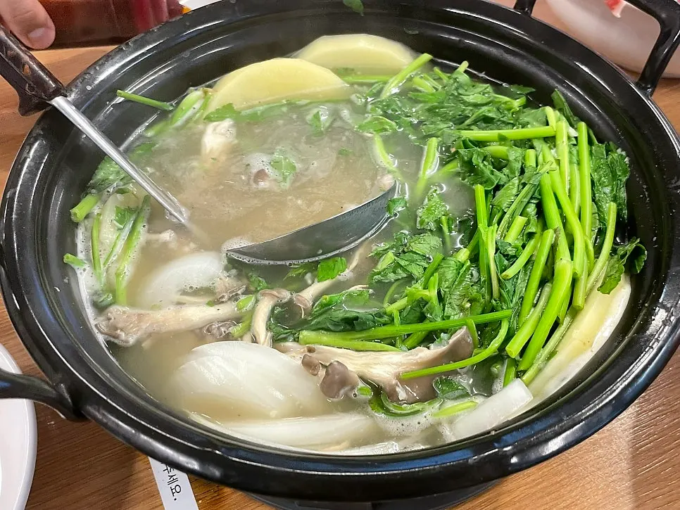 Clear mushroom shabu-shabu broth coming to a boil