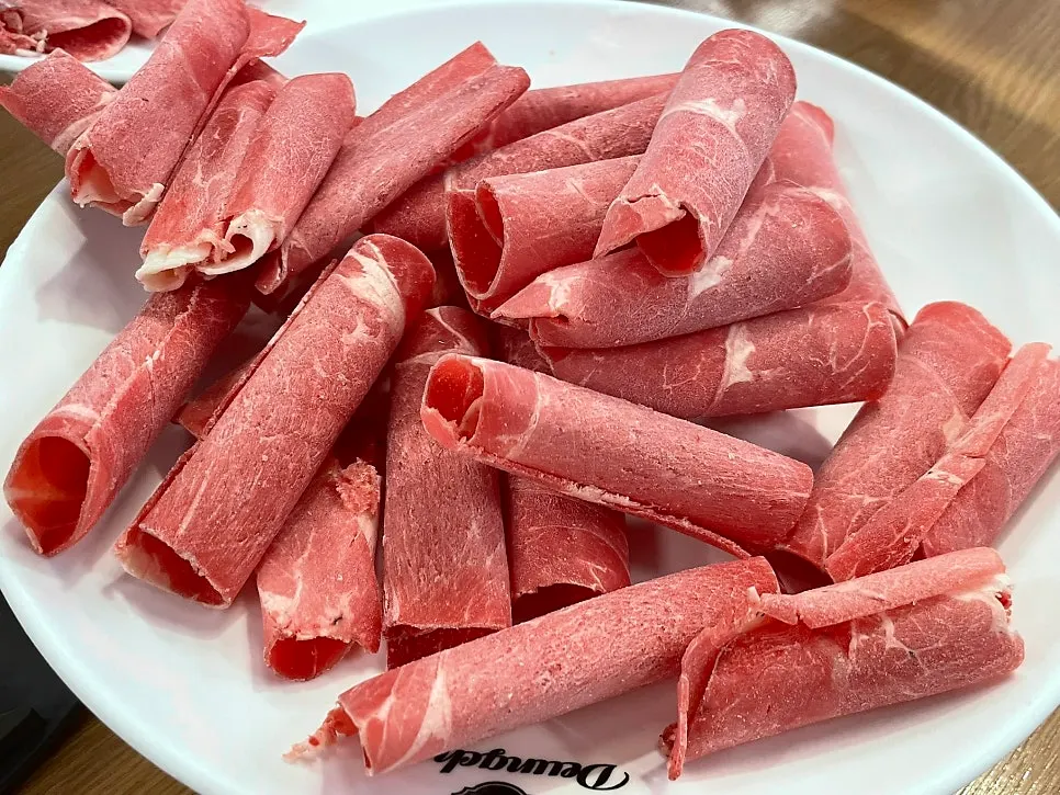 Two added plates of shabu beef