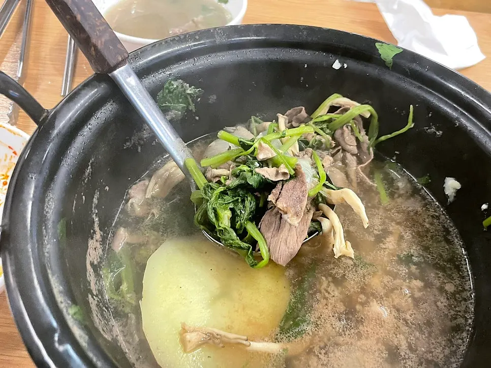 Small plate topped with meat and minari