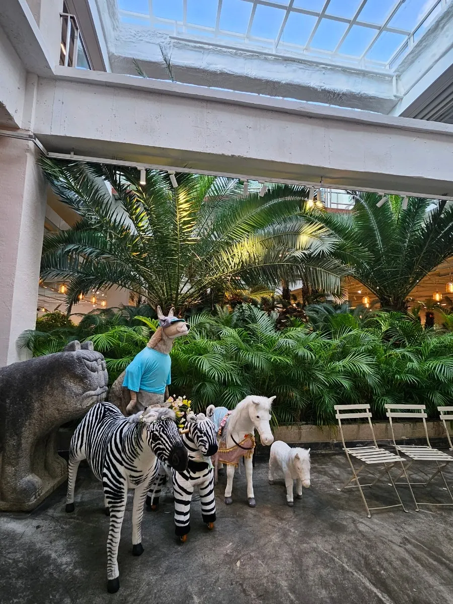 The Doasis hall filled with plants and palm trees