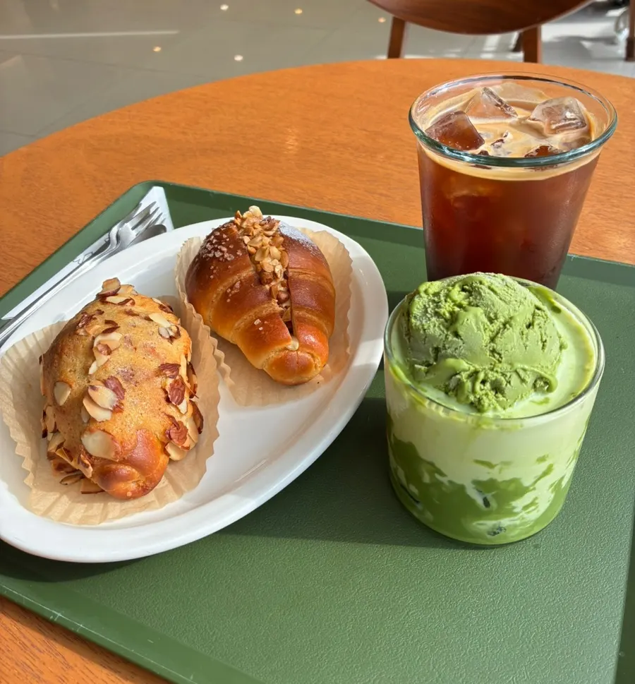 Drink and two kinds of salt bread on a sunny table