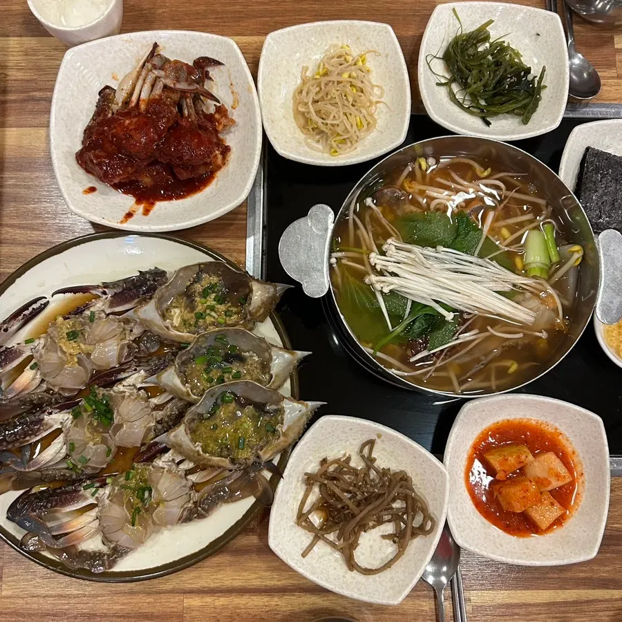 Table set with soy crab, marinated crab, and crab stew
