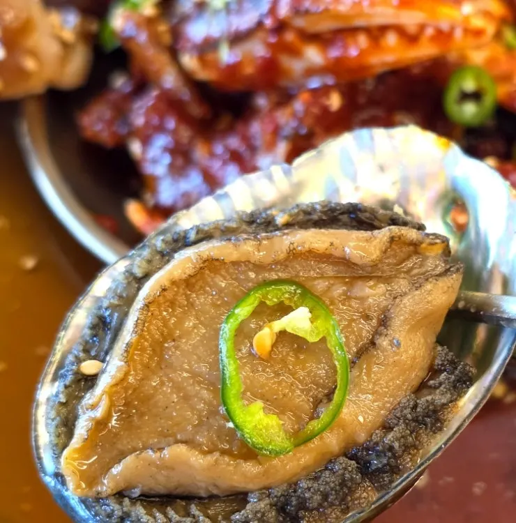 Close-up of marinated abalone and shrimp on the platter