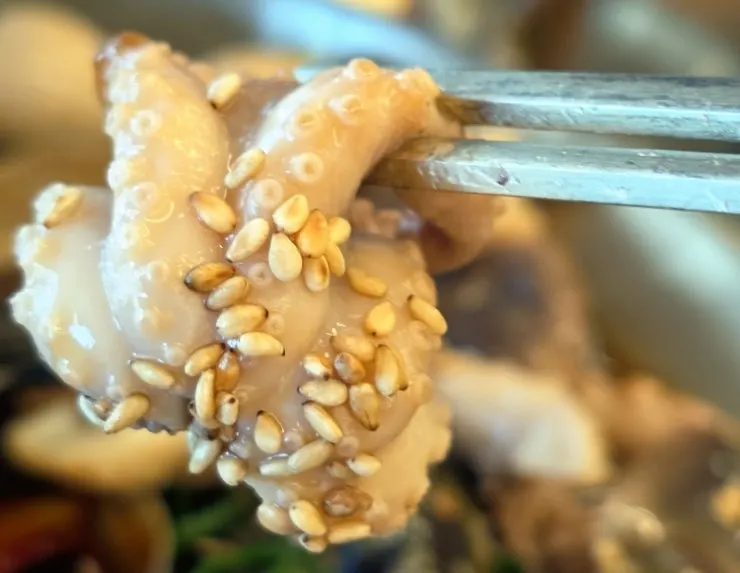 Picking up a piece of soy-marinated crab meat