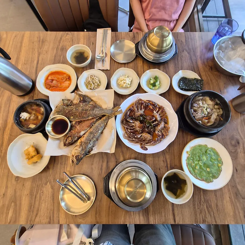 Full spread of the grilled fish and yellow crab pot rice set for two