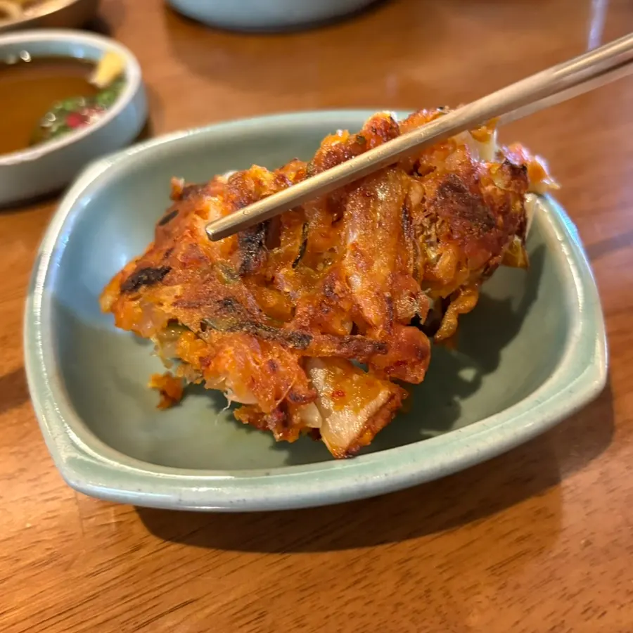 A cross-section of the meat kimchi pancake packed with filling
