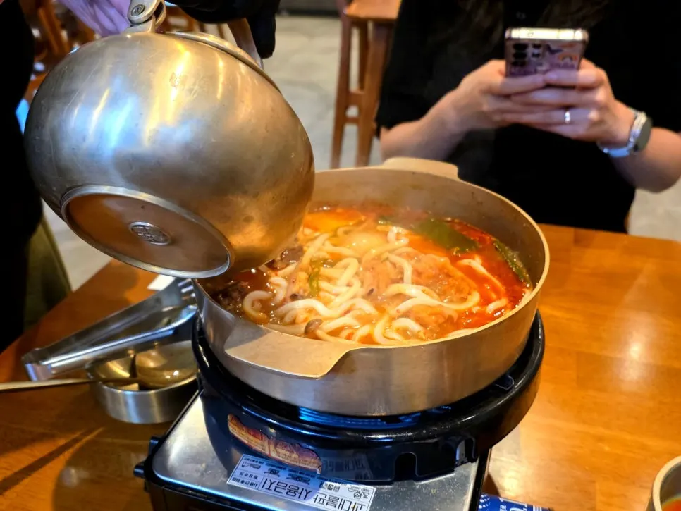 A single bite of brisket and udon noodles together