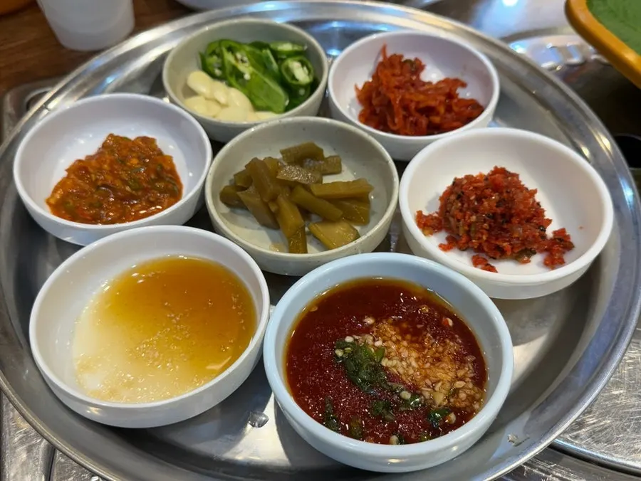 Plate of sauces and jeotgal served with yukhoe