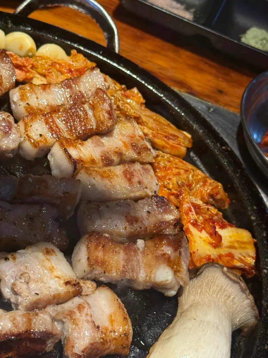 Kimchi served alongside pork belly