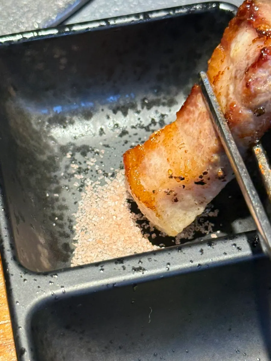 Golden-brown pork belly with wraps being prepared