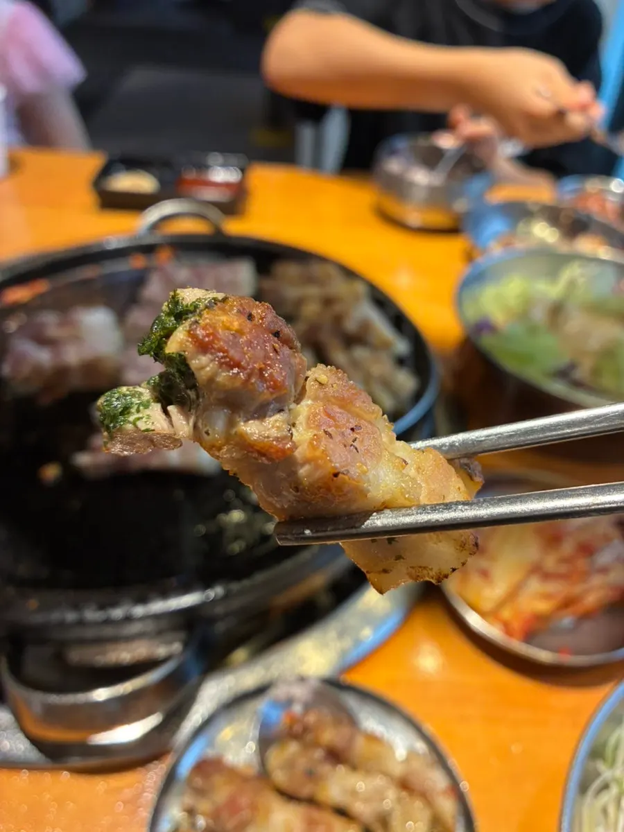 The signature knife-cut pork belly with its scoring opened up