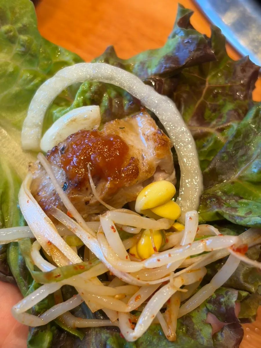 A piece of pork belly dipped in ssamjang