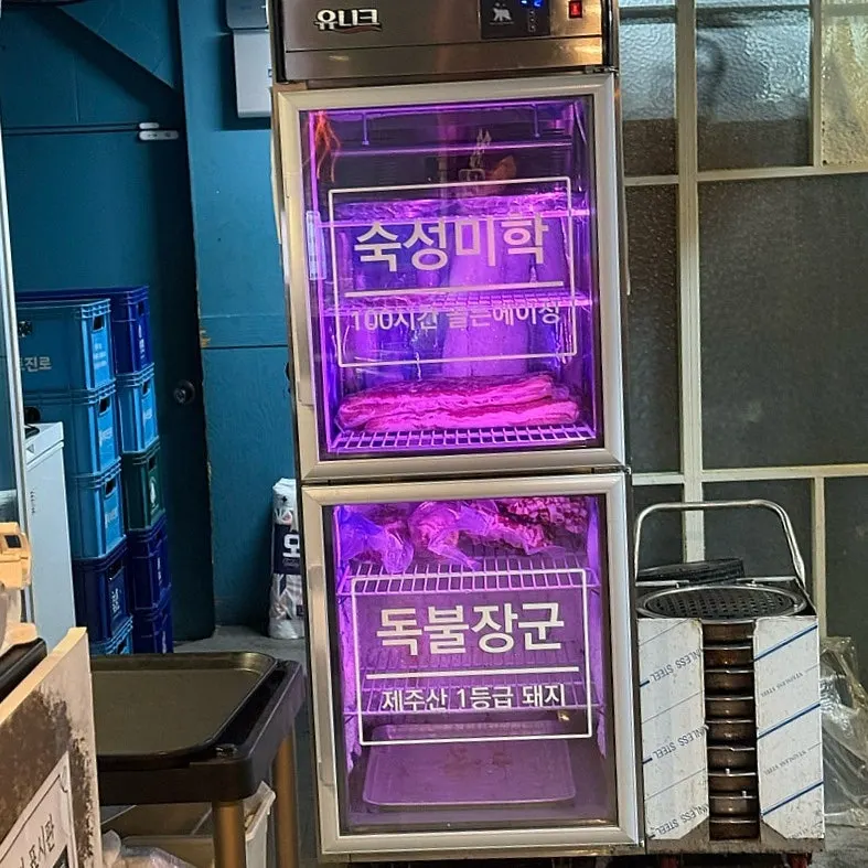 Interior of the restaurant showing the Jeju pork aging fridge