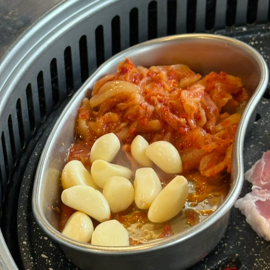 Kimchi and garlic placed on the grill