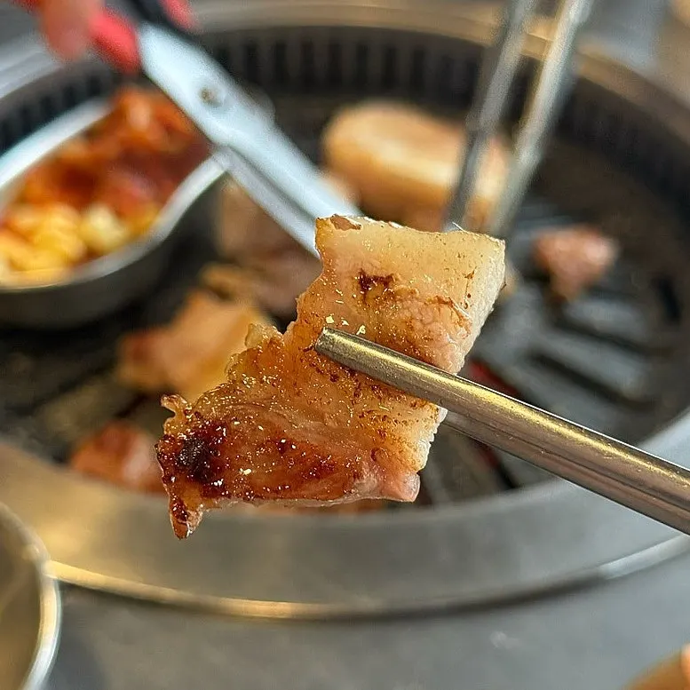 A piece of cheek-neck cut dipped in salt
